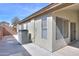 Home exterior showcasing air conditioning unit and access to a concrete patio at 22139 N Van Loo Dr, Maricopa, AZ 85138