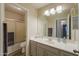 Bathroom with neutral cabinets, large mirror, shower over tub with gray countertops at 22139 N Van Loo Dr, Maricopa, AZ 85138