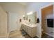 Bathroom boasts double sinks with a large mirror and a door to a private commode at 22139 N Van Loo Dr, Maricopa, AZ 85138