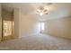 Large bedroom with carpet, ceiling fan, and ensuite bathroom at 22139 N Van Loo Dr, Maricopa, AZ 85138