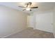 Bedroom with ceiling fan, carpet flooring, and double door closet for lots of storage at 22139 N Van Loo Dr, Maricopa, AZ 85138