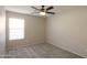 Bright bedroom features a ceiling fan and a window with horizontal blinds at 22139 N Van Loo Dr, Maricopa, AZ 85138