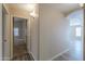 Hallway with wood-look tile flooring and a view of the bedroom and bathroom at 22139 N Van Loo Dr, Maricopa, AZ 85138