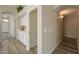 Hallway featuring tile floors, white cabinets, and arched doorway leading to the front door at 22139 N Van Loo Dr, Maricopa, AZ 85138