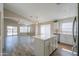 Modern kitchen with a center island, white cabinets, stainless steel appliances, and wood-look floors at 22139 N Van Loo Dr, Maricopa, AZ 85138