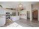 Bright kitchen with island, white cabinetry, hardwood floors, recessed lighting, and stainless appliances at 22139 N Van Loo Dr, Maricopa, AZ 85138