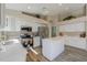 Well-lit kitchen with new stainless steel appliances, white cabinets, quartz countertops, and wood floors at 22139 N Van Loo Dr, Maricopa, AZ 85138