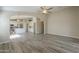 Open living room flows into the kitchen with island and white cabinets, creating an inviting living space at 22139 N Van Loo Dr, Maricopa, AZ 85138