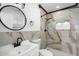 Modern bathroom featuring marble-style tile, white vanity and a shower with built-in niche at 2215 N 58Th Dr, Phoenix, AZ 85035