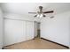 Bedroom with laminate floors, ceiling fan, white walls, and large closet at 2215 N 58Th Dr, Phoenix, AZ 85035