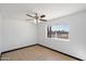 Bedroom featuring ceiling fan, window, and laminate floors at 2215 N 58Th Dr, Phoenix, AZ 85035