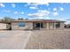 Inviting single-story home with a classic desert landscape and a covered porch entrance at 2215 N 58Th Dr, Phoenix, AZ 85035