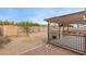 Backyard featuring a covered patio, desert landscaping, and a storage shed at 2558 W Jasper Ave, Apache Junction, AZ 85120