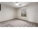 Bedroom with large window, ceiling fan, and neutral carpeting at 2558 W Jasper Ave, Apache Junction, AZ 85120