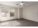 Sunlit bedroom with carpet, ceiling fan, and two windows at 2558 W Jasper Ave, Apache Junction, AZ 85120