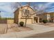 Inviting two-story house featuring a well-manicured lawn and a cozy front porch at 2558 W Jasper Ave, Apache Junction, AZ 85120