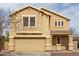 Charming two-story home with tan stucco, well-maintained landscaping, and a welcoming front entrance at 2558 W Jasper Ave, Apache Junction, AZ 85120