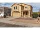 Charming two-story home with tan stucco, well-maintained landscaping, and a welcoming front entrance at 2558 W Jasper Ave, Apache Junction, AZ 85120