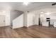 Open concept living space with hardwood floors, white walls, a ceiling fan, and a view of the kitchen at 2558 W Jasper Ave, Apache Junction, AZ 85120