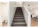 Carpeted staircase leading to the upper level of the home, with a view into the modern kitchen at 2558 W Jasper Ave, Apache Junction, AZ 85120