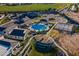 An aerial view of a clubhouse, pool, and tennis courts in a planned community at 2779 E Derringer Way, Gilbert, AZ 85295