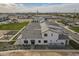 Expansive aerial view of homes featuring gray roofs, desert landscaping, and community amenities at 2779 E Derringer Way, Gilbert, AZ 85295