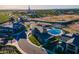 Aerial view of a clubhouse, pool, and tennis court in a planned community at 2779 E Derringer Way, Gilbert, AZ 85295