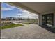 Wide-open covered back porch featuring brick pavers and a view of the community at 2779 E Derringer Way, Gilbert, AZ 85295