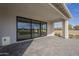 Covered back porch featuring modern sliding glass doors and neutral pavers at 2779 E Derringer Way, Gilbert, AZ 85295