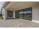 Large back patio featuring modern black sliding glass doors and neutral pavers at 2779 E Derringer Way, Gilbert, AZ 85295