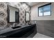 Modern bathroom with geometric tile backsplash, dark counters, and dual vanities at 2779 E Derringer Way, Gilbert, AZ 85295