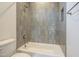 Bathroom featuring a tiled shower-tub and toilet at 2779 E Derringer Way, Gilbert, AZ 85295