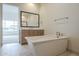 Bright bathroom featuring a freestanding tub and vanity with a framed mirror at 2779 E Derringer Way, Gilbert, AZ 85295