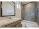 Bathroom featuring a tiled shower, toilet, and vanity with a framed mirror at 2779 E Derringer Way, Gilbert, AZ 85295