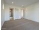 Spacious bedroom with neutral carpet, featuring doorways to a closet and a bathroom at 2779 E Derringer Way, Gilbert, AZ 85295