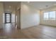 An empty bedroom with hardwood floors, a closet, and a window letting in natural light at 2779 E Derringer Way, Gilbert, AZ 85295