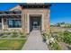 Grand entrance features stone accents, modern glass doors, and lush floral arrangements at 2779 E Derringer Way, Gilbert, AZ 85295