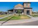 Daytime view of clubhouse featuring a stone facade, covered patio, and lush green lawn at 2779 E Derringer Way, Gilbert, AZ 85295