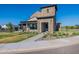 Daytime view of clubhouse featuring a stone facade, covered patio, and lush green lawn at 2779 E Derringer Way, Gilbert, AZ 85295