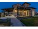 Beautiful exterior of stone building with covered patio, landscaping, and inviting entrance at twilight at 2779 E Derringer Way, Gilbert, AZ 85295