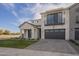 Beautiful modern home with a brick driveway, white brick exterior, and gray accents at 2779 E Derringer Way, Gilbert, AZ 85295