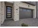 Close up of garage door and entrance of modern home with gray garage door at 2779 E Derringer Way, Gilbert, AZ 85295