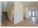 Hallway with staircase, hardwood floors, and doorways leading to other parts of the home at 2779 E Derringer Way, Gilbert, AZ 85295