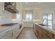 Modern kitchen with stainless steel appliances, island, white countertops and white cabinetry at 2779 E Derringer Way, Gilbert, AZ 85295