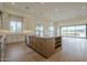 Open concept kitchen with stainless steel appliances, island and view into great room at 2779 E Derringer Way, Gilbert, AZ 85295