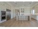 Spacious modern kitchen with stainless steel appliances, white countertops and wood floors at 2779 E Derringer Way, Gilbert, AZ 85295