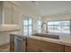 Open concept kitchen with island, dishwasher and stainless steel faucet at 2779 E Derringer Way, Gilbert, AZ 85295