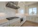 Modern kitchen with stainless steel range hood and white countertops at 2779 E Derringer Way, Gilbert, AZ 85295