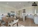 Virtually staged kitchen with stainless steel appliances, a central island, and an adjacent dining area at 2779 E Derringer Way, Gilbert, AZ 85295