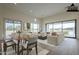 A bright, virtually staged living room with a dining area and comfortable seating arrangement at 2779 E Derringer Way, Gilbert, AZ 85295